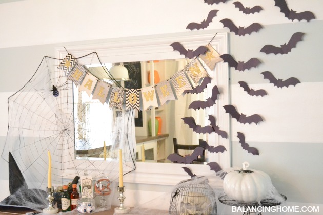 A spooky Halloween mantle that is witch themed. 